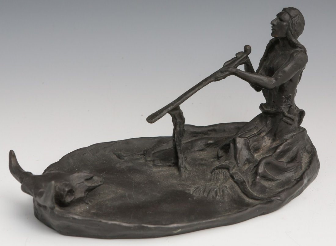 AFTER C M RUSSELL BRONZE INDIAN & STEER SKULL: AFTER C M RUSSELL BRONZE INDIAN & STEER SKULL Indian & Steer Skull, "Peace Pipe": Smoking with the spirit of the steer skull. Signed C M Russell. Impressed B. Zoppo Foundry, N.Y. Size: 8" long