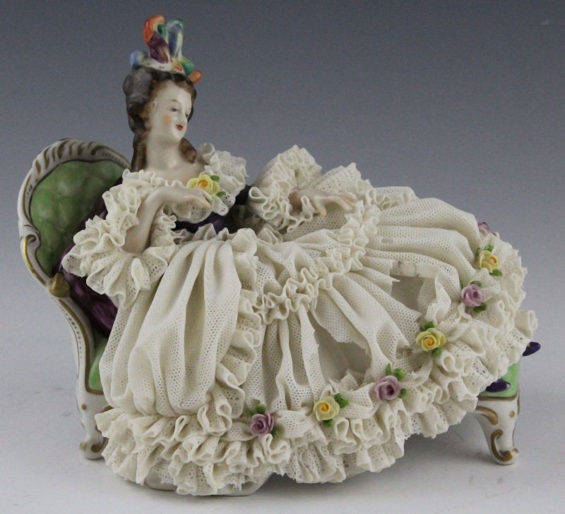 GERMAN DRESDEN LACE PORCELAIN FIGURE: GERMAN DRESDEN LACE PORCELAIN FIGURE German Dresden Lace Porcelain Figure, woman in large lace dress resting on couch, marked on bottom. Size: 11 x 8" Condition: Good, loss to porcelain lace dress.