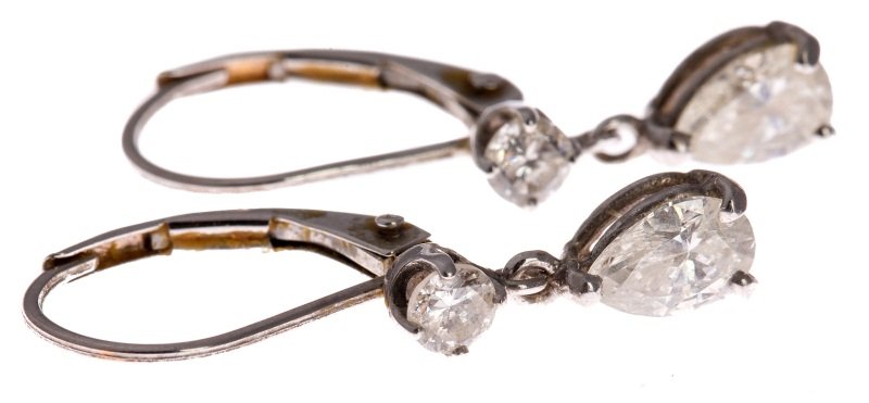 14K WHITE GOLD DIAMOND DANGLE EARRINGS 1 CTW: 14K WHITE GOLD DIAMOND DANGLE EARRINGS 1 CTW 14K white gold earrings. Each with a dangly pear diamond of approximately 0.4 ct and a round diamond of 0.1 ct. Approximately 1 Ctw for the pair. Diamonds