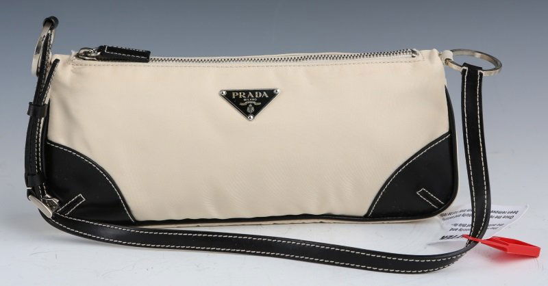PRADA CREAM COLORED LEATHER SEMITRACOLLA HAND BAG: PRADA CREAM COLORED LEATHER SEMITRACOLLA HAND BAG Prada Tessuto light Semitracolla hand bag, black leather arm strap, top zipper, Prada front plaque, fully lined inside with both cards of authenticity