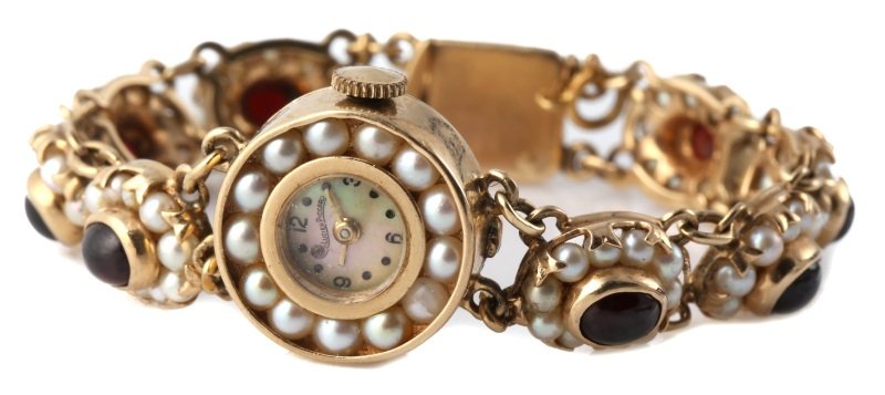 14K GOLD LUCIEN PICCARD PEARL & GARNET WATCH: 14K GOLD LUCIEN PICCARD PEARL & GARNET WATCH Ladies 14K yellow gold Lucien Piccard wristwatch. Mother of Pearl face surrounded by pearls. Band has 8 cabochon oval garnet stones. Each garnet is surroun