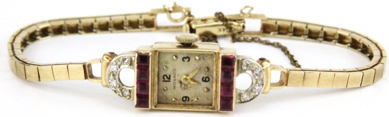 LADIES 14K DIAMOND & RUBY MOVADO WRISTWATCH: LADIES 14K DIAMOND & RUBY MOVADO WRISTWATCH Movado, 7551 Swiss movement, 17 jewels, unadjusted, 14K yellow gold case, white face with some discoloration, Arabic numerals, no second hand, ruby and diam