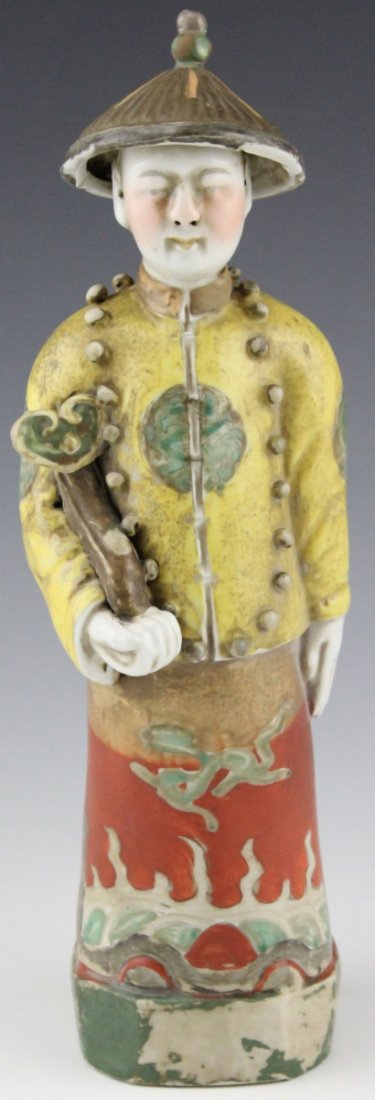 CHINESE FAMILLE ROSE FIGURAL STATUE MAN WITH RUYI: CHINESE FAMILLE ROSE FIGURAL STATUE MAN WITH RUYI Chinese porcelain figure of man with Ruyi and pointed hat, famille rose, two marks to bottom. Size: 9"