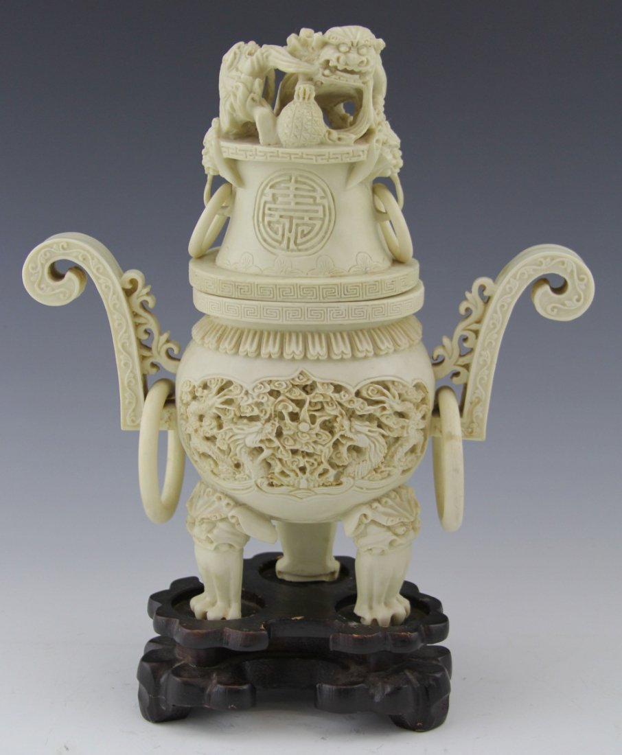 COMPOSITE FOOTED CHINESE CENSER FOO DOGS: COMPOSITE FOOTED CHINESE CENSER FOO DOGS Composite Chinese footed censer foo dog motif. Comes with wooden stand. Size: 12" with stand