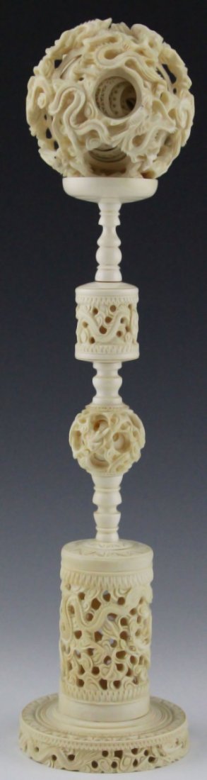 LARGE CHINESE CARVED IVORY DRAGON PUZZLE BALL: LARGE CHINESE CARVED IVORY DRAGON PUZZLE BALL Impressive Chinese carved ivory puzzle ball on large ivory stand. Detailed dragon carved motif throughout. Puzzle ball contains at least 15 individually c