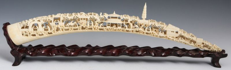 CHINESE CARVED IVORY TUSK VILLAGE SCENE: CHINESE CARVED IVORY TUSK VILLAGE SCENE Chinese carved elephant ivory tusk of village scene. Fully reticulated and with intricately carved details. Pagoda is removable. Includes repaired wood stand. W