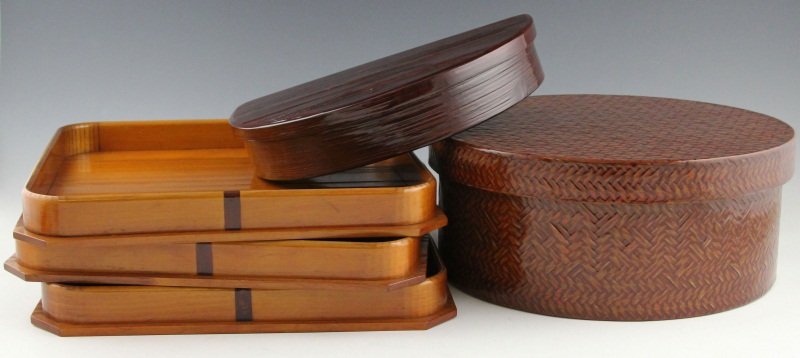 (5) LARGE JAPANESE BENTO BOXES WITH TRAYS: (5) LARGE JAPANESE BENTO BOXES WITH TRAYS Five pieces of Japanese lacquer ware, includes large weaved bento box with multicolored lacquer detail, 12 x 5", dark lacquer semi circle bento box with natur