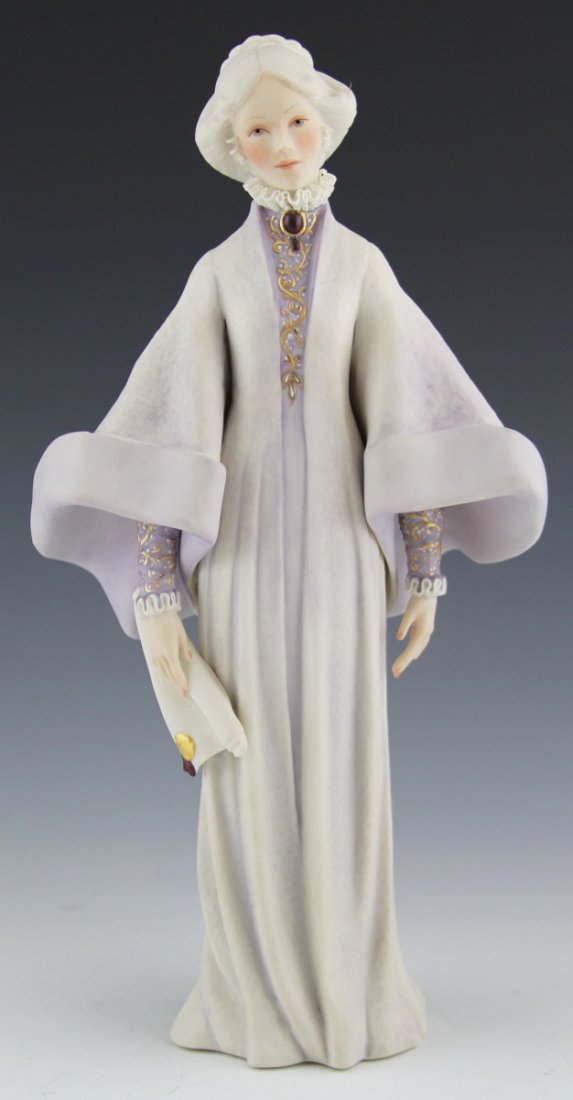 CYBIS PORCELAIN FIGURE OF A WOMAN WITH SCROLL: CYBIS PORCELAIN FIGURE OF A WOMAN WITH SCROLL Cybis porcelain figure of a woman with scroll in hand wearing a flowing purple and white robe. Size: 13"