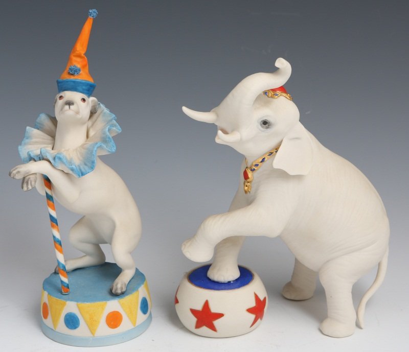 (2) CYBIS PORCELAIN CIRCUS ANIMAL FIGURINES: (2) CYBIS PORCELAIN CIRCUS ANIMAL FIGURINES (2) Cybis porcelain circus animals. An elephant with gold and red details and a dog with orange and blue details. Both are signed on base. Size: 7, 8.25"