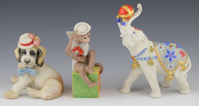 (3) CYBIS PORCELAIN ANIMAL FIGURINES: (3) CYBIS PORCELAIN ANIMAL FIGURINES Three Cybis bisque porcelain animal figurines, made in U.S.A. Includes Saint Bernard puppy in hat with flower, 4.75", 1982; Monkey dressed as sailor seated on cube