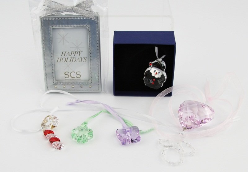 (6) SWAROVSKI CRYSTAL GIFT TYPE PIECES: (6) SWAROVSKI CRYSTAL GIFT TYPE PIECES Six Swarovski Crystal gift pieces. Group includes one small Santa ornament, a candy cane on a necklace-length ribbon, 2008 pink heart with a bead on wire portion
