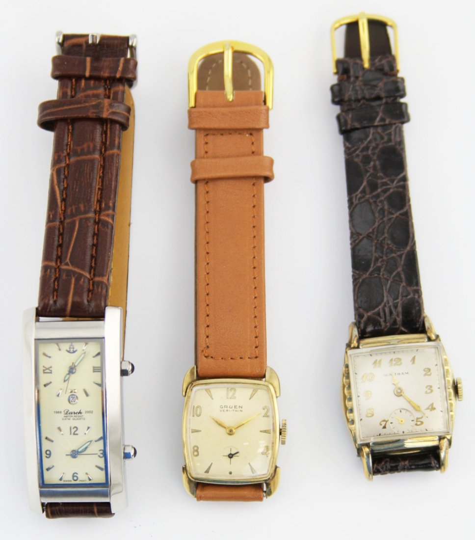 (3) MENS WATCHES WITH LEATHER BANDS: (3) MENS WATCHES WITH LEATHER BANDS Three men's wristwatches with leather bands. Group includes a Waltham with black crocodile pattern band 27mm, a Gruen Veri-Thin with light brown band 23mm, and a Da