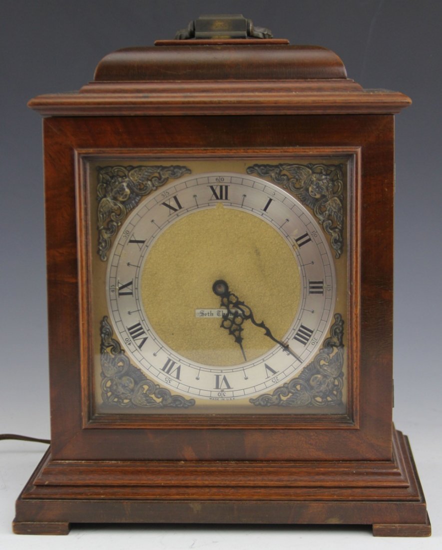 SETH THOMAS ELECTRICAL WOOD MANTEL CLOCK: SETH THOMAS ELECTRICAL WOOD MANTEL CLOCK Seth Thomas electrical wood mantel clock 1969-1974. Roman numerals and floral scrolling to face. Size: 13 x 9"