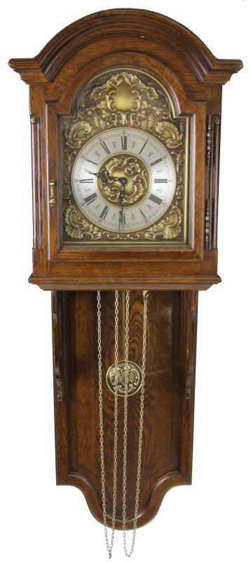 20TH CENTURY FLEMISH WALL CLOCK: 20TH CENTURY FLEMISH WALL CLOCK Antique Flemish wall clock, circa 1900's. Carved oak body with brass works, grape motif around chapter ring and on pendulum, pierced black spandrels. Includes three wei