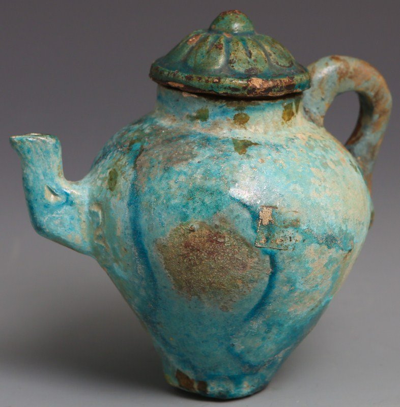 HAND MADE CHINESE EARTHENWARE TEAPOT: HAND MADE CHINESE EARTHENWARE TEAPOT Antique Chinese hand made earthen ware tea pot with floral motif lid. Aged paper label on underside with four handwritten Chinese characters. Significant wear and