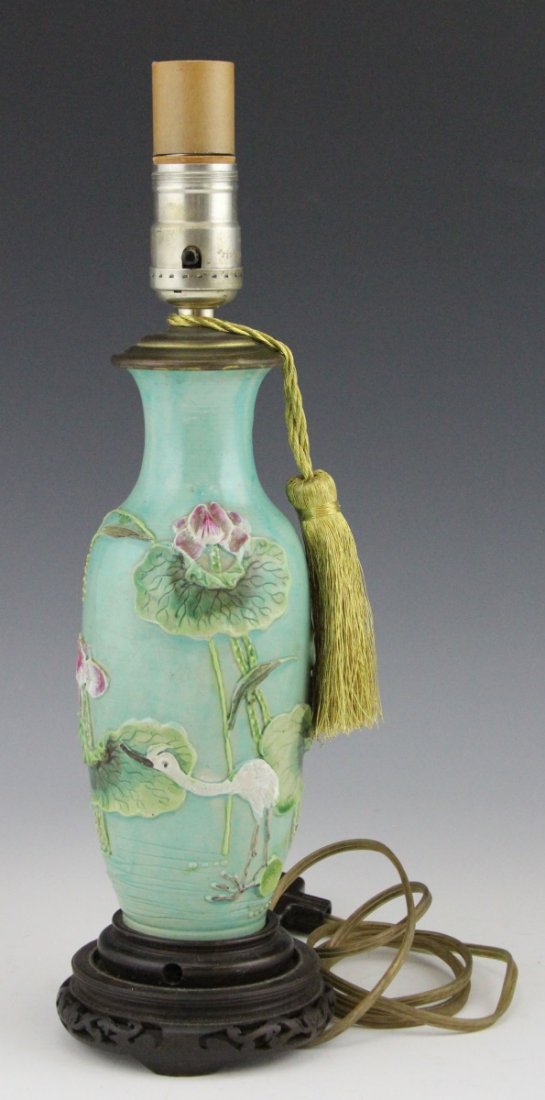 CHINESE BOTTLE VASE LAMP WITH CRANE MOTIF: CHINESE BOTTLE VASE LAMP WITH CRANE MOTIF A Chinese earthenware bottle vase with crane and water lily imagery in relief. Has been converted to a lamp. Size: 15"