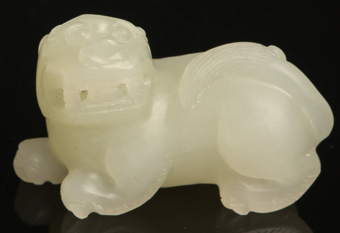 CHINESE CELADON JADE CARVING OF FOO DOG: CHINESE CELADON JADE CARVING OF FOO DOG White jade carving of foo dog. Weight: 50.2g Size: 2 x 1.25 x 1"