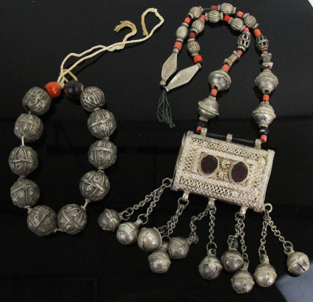 (2) ANTIQUE BEDOUIN SILVER NECKLACES: (2) ANTIQUE BEDOUIN SILVER NECKLACES Two antique Bedouin silver necklaces, both with carnelian accents, one has hirz pendant with red glass accents. Weight: 264.4g