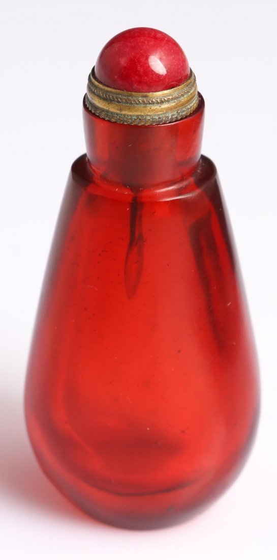 CHINESE GLASS SNUFF BOTTLE: CHINESE GLASS SNUFF BOTTLE Red glass snuff bottle, Chinese, brass top with carnelian accents. Weight: 52.7g Size: 30"