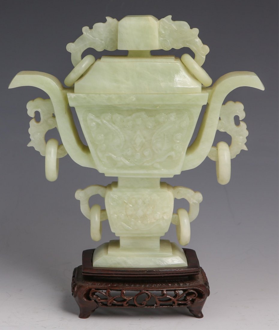 CHINESE CARVED SERPENTINE LIDDED URN: CHINESE CARVED SERPENTINE LIDDED URN Chinese carved serpentine lidded urn with dragon motif. Comes with wooden base. Weight: 770g Size: 6.75" plus stand