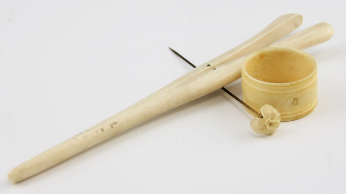 (3) IVORY ACCESSORIES: (3) IVORY ACCESSORIES Three ivory accessories. Includes: glove stretcher (47.4g), flower stick pin (2.7g), and simple napkin ring holder (11.2g). Early 20th C.