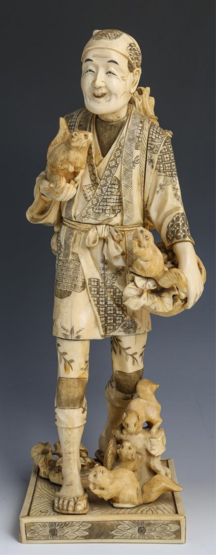 JAPANESE CARVED IVORY OKIMONO MAN W SQUIRRELS: JAPANESE CARVED IVORY OKIMONO MAN W SQUIRRELS Large Japanese carved ivory okimono, mid to late 19th C., depicting a walking man with a basket of fruiting branches and a dray of squirrels; a basket of 