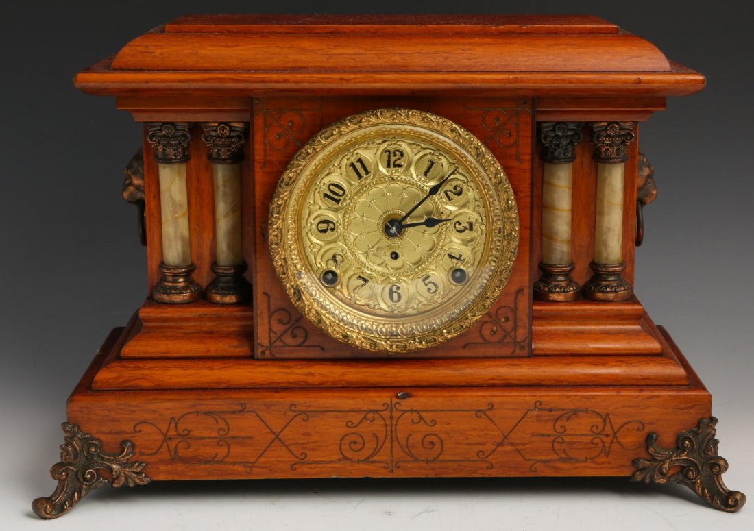 WOODEN CASE MANTEL CLOCK WITH GILT FACE: WOODEN CASE MANTEL CLOCK WITH GILT FACE Wooden case mantel clock with gilt face. Inside the back of the clock is a sticker that reads "Lundblad's Jewelers New Haven, Conn." Numbers are Arabic and blac