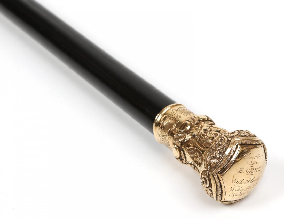 VICTORIAN EBONY PRESENTATION CANE GF HANDLE 1874: VICTORIAN EBONY PRESENTATION CANE GF HANDLE 1874 Victorian presentation ebony walking cane, featuring a gold-filled scroll knob handle, engraved "Presented to E. Gratz , by LA Levy, Tishry 5635, Sept.