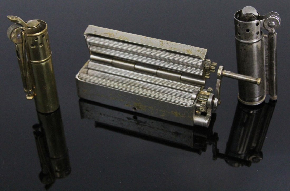 CIGARETTE ROLLER AND TWO LIGHTERS: CIGARETTE ROLLER AND TWO LIGHTERS Cigarette roller by Abadie Paris, a sterling lighter by Dunhill, and a brass lighter by IMCO. Cigarette roller is still operational, however the two lighters are not.