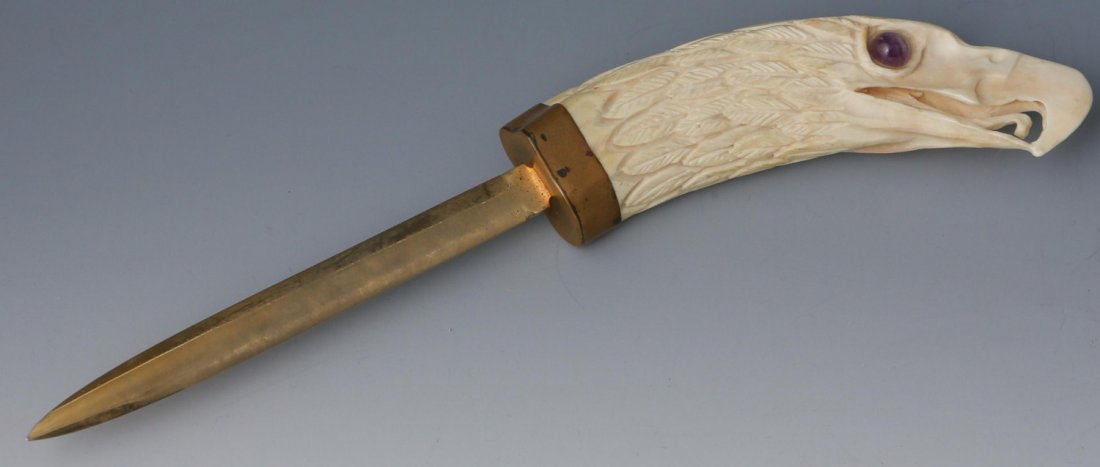 EARLY 20TH C IVORY EAGLE HEAD LETTER OPENER: EARLY 20TH C IVORY EAGLE HEAD LETTER OPENER Ivory carved eagle head letter opener, early 20th C., studded with cabochon amethyst eyes; metal cap and blade. Unmarked. Provenance: Private Florida estate