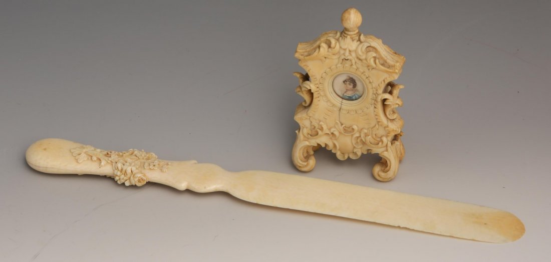 19TH C. CONTINENTAL IVORY LETTER OPENER AND FRAME: 19TH C. CONTINENTAL IVORY LETTER OPENER AND FRAME 19th century Continental ivory letter opener and small painted portrait frame. Letter opener has flower details on the handle and measures 10.75". The