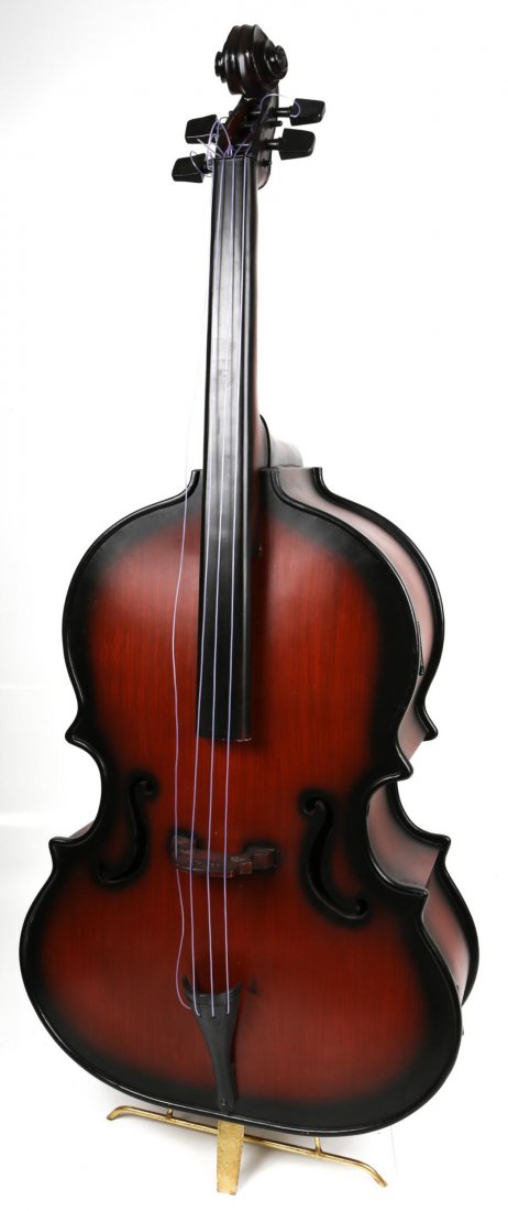UPRIGHT BASS CABINET: UPRIGHT BASS CABINET Upright bass cabinet with six storage shelves and a hinged door, propped on a gold color metal stand. Size: 77 x 30 x 16"