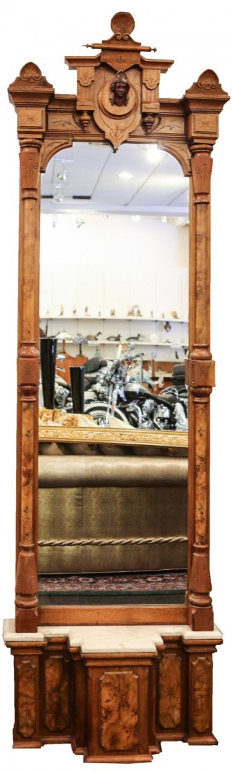 EASTLAKE PIER MIRROR: EASTLAKE PIER MIRROR Eastlake pier mirror with geometric design, and a woman's face in the center of the top decorative feature. Mirror inside the frame is 72 x 23" and the base is 31 x 17" with a mar