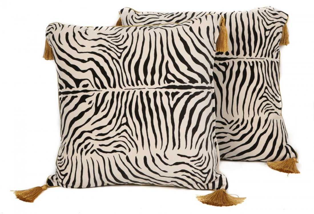 (2) ZEBRA PRINT VELOUR PILLOWS W/ TASSELS: (2) ZEBRA PRINT VELOUR PILLOWS W/ TASSELS Two zebra print velour pillows with gold tassels. Front of the pillow is zebra print, while the other side is dark grey with a small gold crown emblem in the 