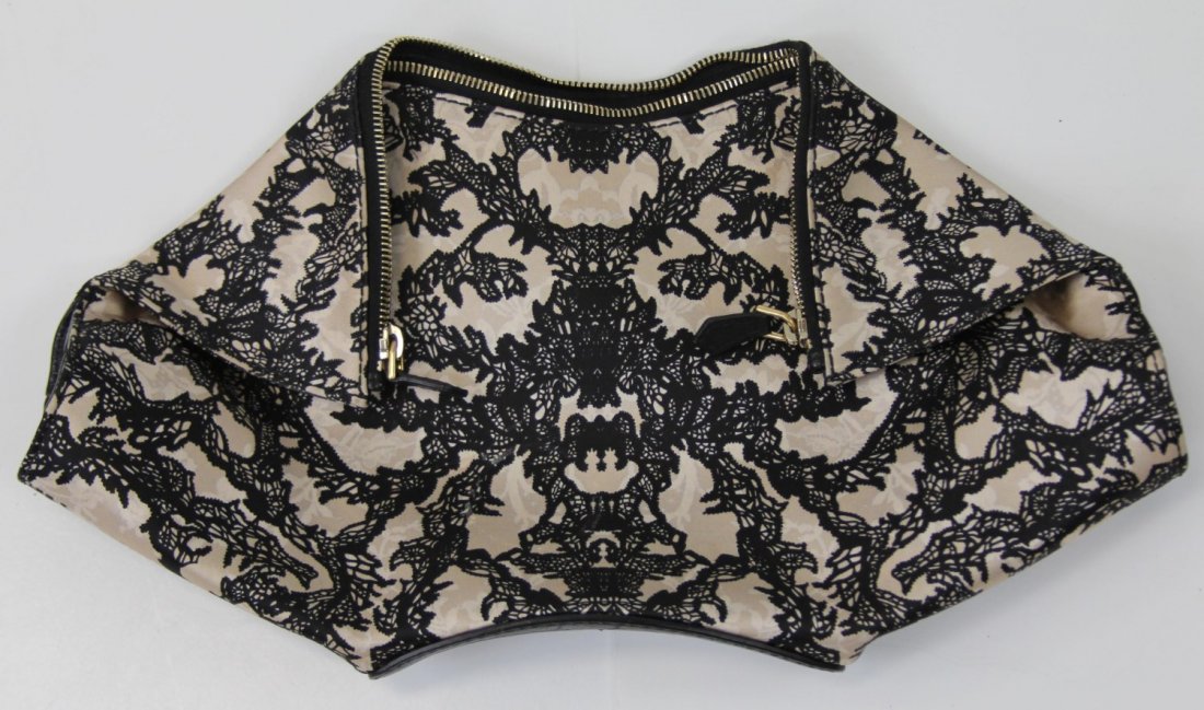 ALEXANDER MCQUEEN SATIN CLUTCH PURSE: ALEXANDER MCQUEEN SATIN CLUTCH PURSE Alexander McQueen lace pattern satin clutch purse with magnetic components and gold metal zipper. Stamped "Alexander McQueen Made in Italy" on a piece of leather o