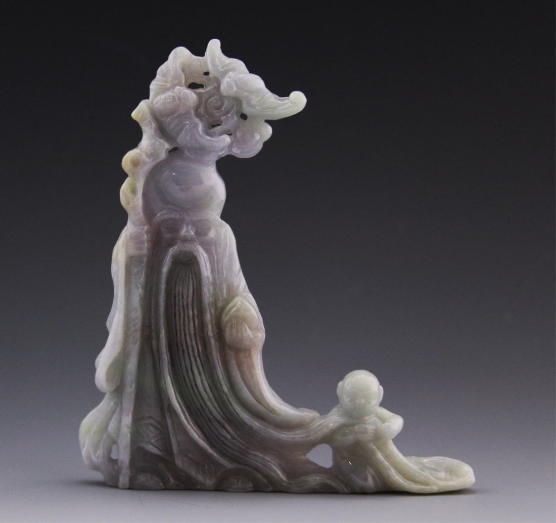 LAVENDER JADEITE CARVING OF SHOU: LAVENDER JADEITE CARVING OF SHOU Lavender jadeite carving of Shou, the god of longevity, (from The Three Stars) with a baby to one side of him. Carving is high polished and relatively low relief. Weig