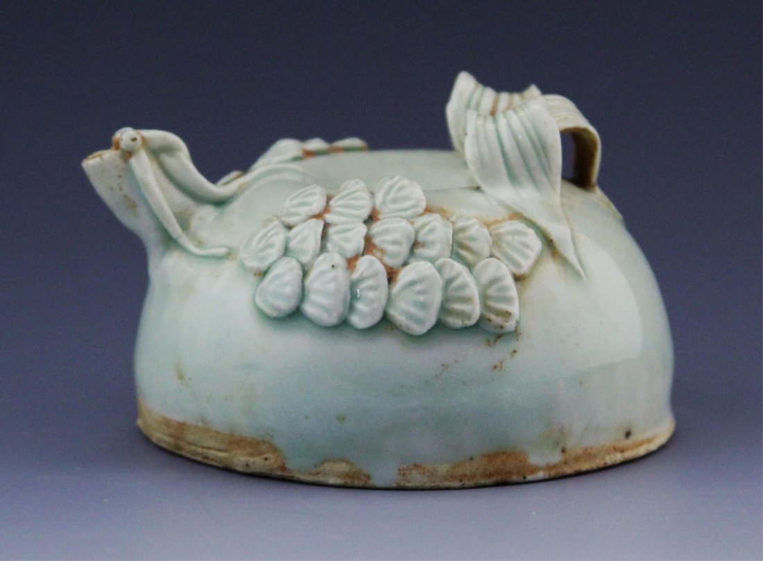 SMALL CELADON GLAZE EARTHENWARE WATER DROPPER: SMALL CELADON GLAZE EARTHENWARE WATER DROPPER Small earthenware water dropper with a celadon glaze and foliage decorative motif. Weight: 146.8g Size: 3.5 x 2"