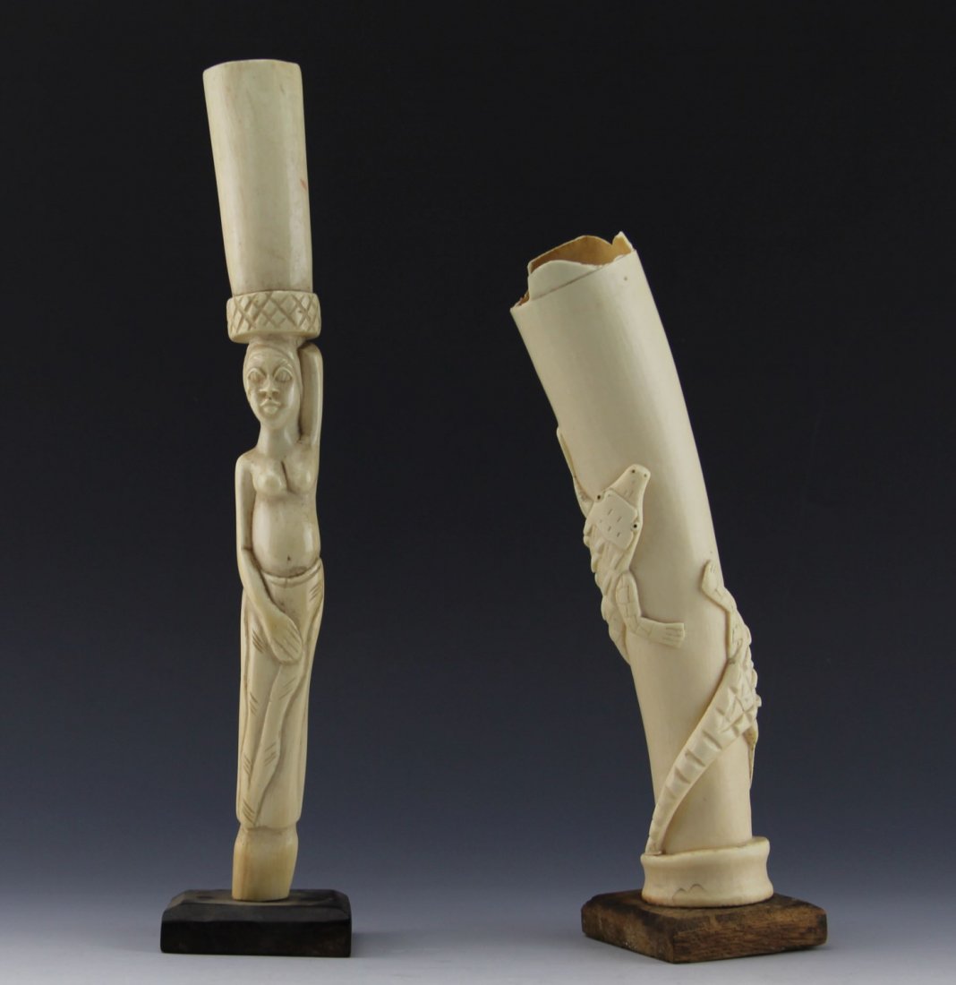 (2) AFRICAN IVORY TRIBAL CARVING ELEPHANT TUSKS: (2) AFRICAN IVORY TRIBAL CARVING ELEPHANT TUSKS Lot of two antique African carved ivory elephant tusks; Includes figural woman with basket, 12.5", and hollow tusk segment with stylized crocodile wrapp