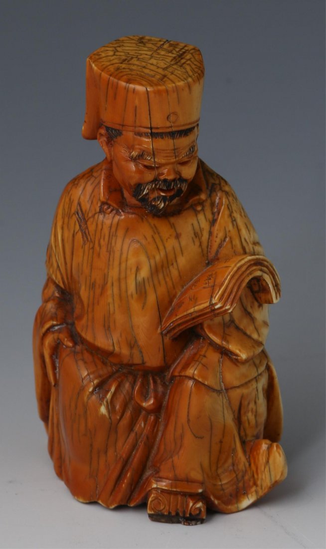 19 C CHINESE CARVED IVORY SEATED SCHOLAR FIGURE: 19 C CHINESE CARVED IVORY SEATED SCHOLAR FIGURE 19th century Chinese carved ivory figure of seated scholar with scroll. Tea stained with induced craquelure to robe and hat, signature to bottom. Weight