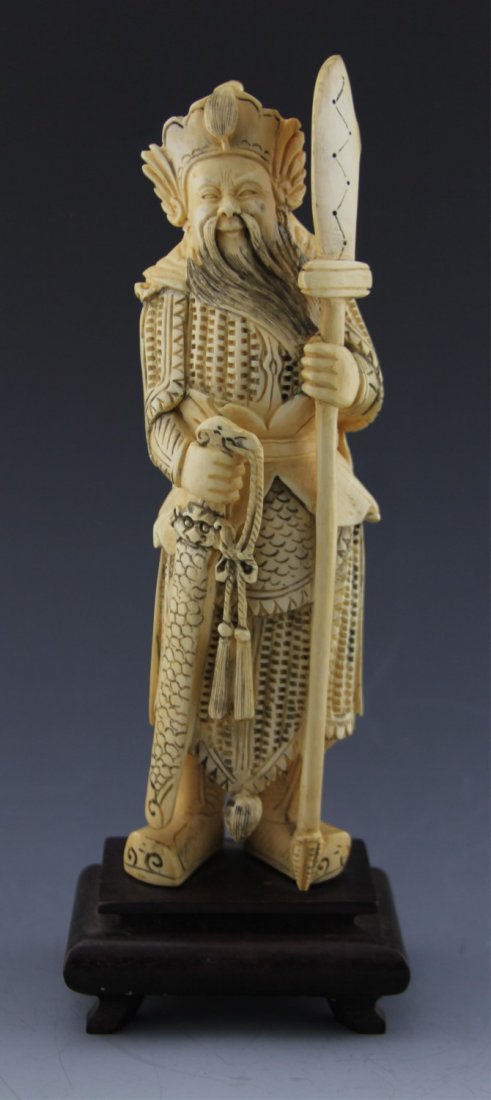 ANTIQUE CHINESE CARVED IVORY WARRIOR FIGURE: Antique Chinese carved ivory figure of warrior in uniform with weapons, attached to wooden base. Weight: 526 g total. Size: 8.5" plus base.