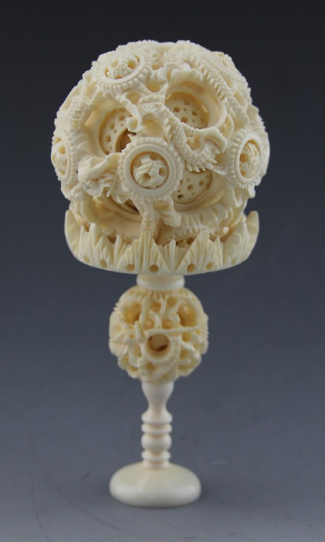 ANTIQUE CHINESE CARVED IVORY PUZZLE BALL: Antique Chinese carved ivory puzzle ball, dragon motif, balls have multiple layers. Weight: 130 g. Size: 6".