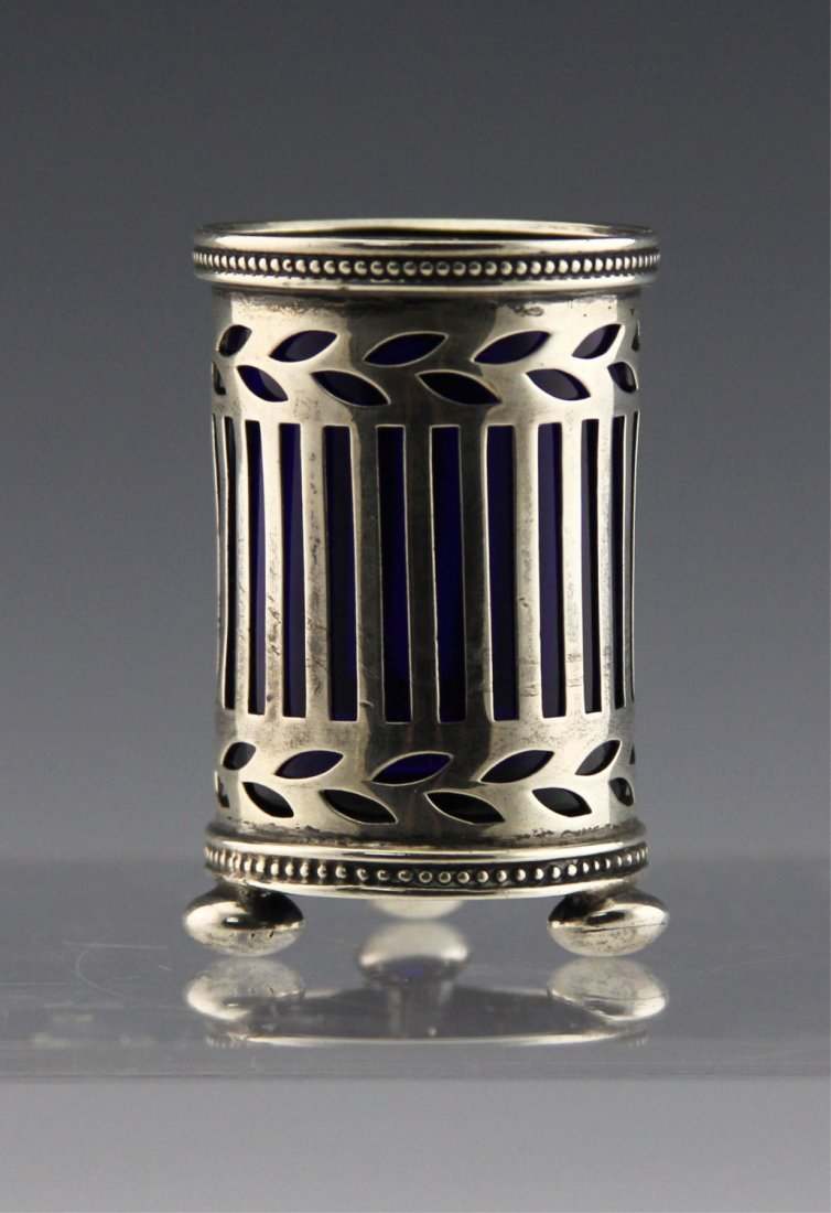 TIFFANY & CO SILVER & GLASS TOOTHPICK HOLDER: TIFFANY & CO SILVER & GLASS TOOTHPICK HOLDER Tiffany & Co. sterling silver and cobalt blue glass toothpick holder, footed. hallmarked around base. Weight: 73.4g Size: 2.25 x 1.5"