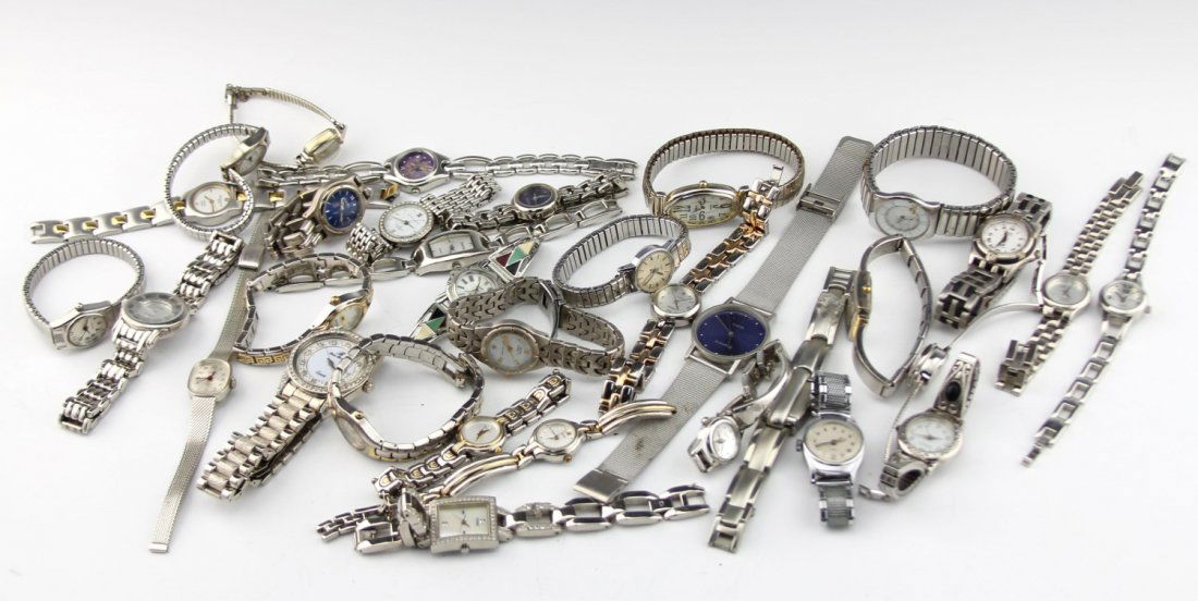 (33) LADIES FASHION WATCHES: (33) LADIES FASHION WATCHES A large lot of ladies mostly silver-tone costume quartz fashion watches. Some brands included are Anne Klein II, Helbros, Waltham and more. Weight: 1225 g