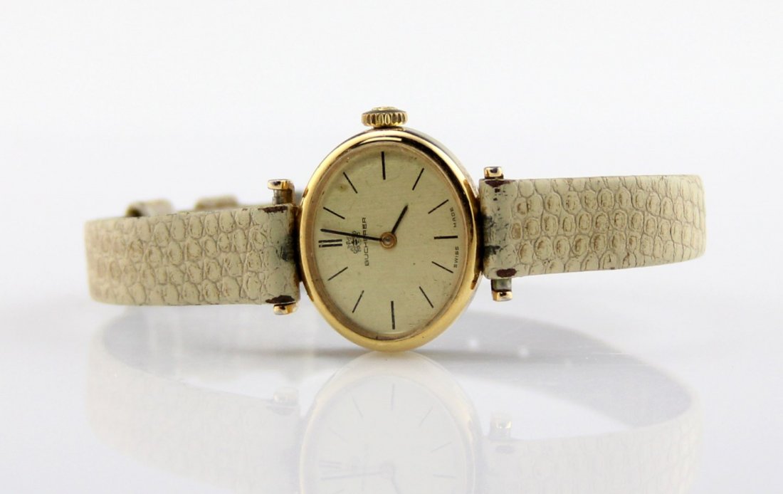 VINTAGE LADIES BUCHERER WRIST WATCH: VINTAGE LADIES BUCHERER WRIST WATCH Vintage ladies Bucherer automatic wrist watch with a Hirsch band. Gold dial with black markers. Watch measures 9 x 8mm. Weight: 13.7g