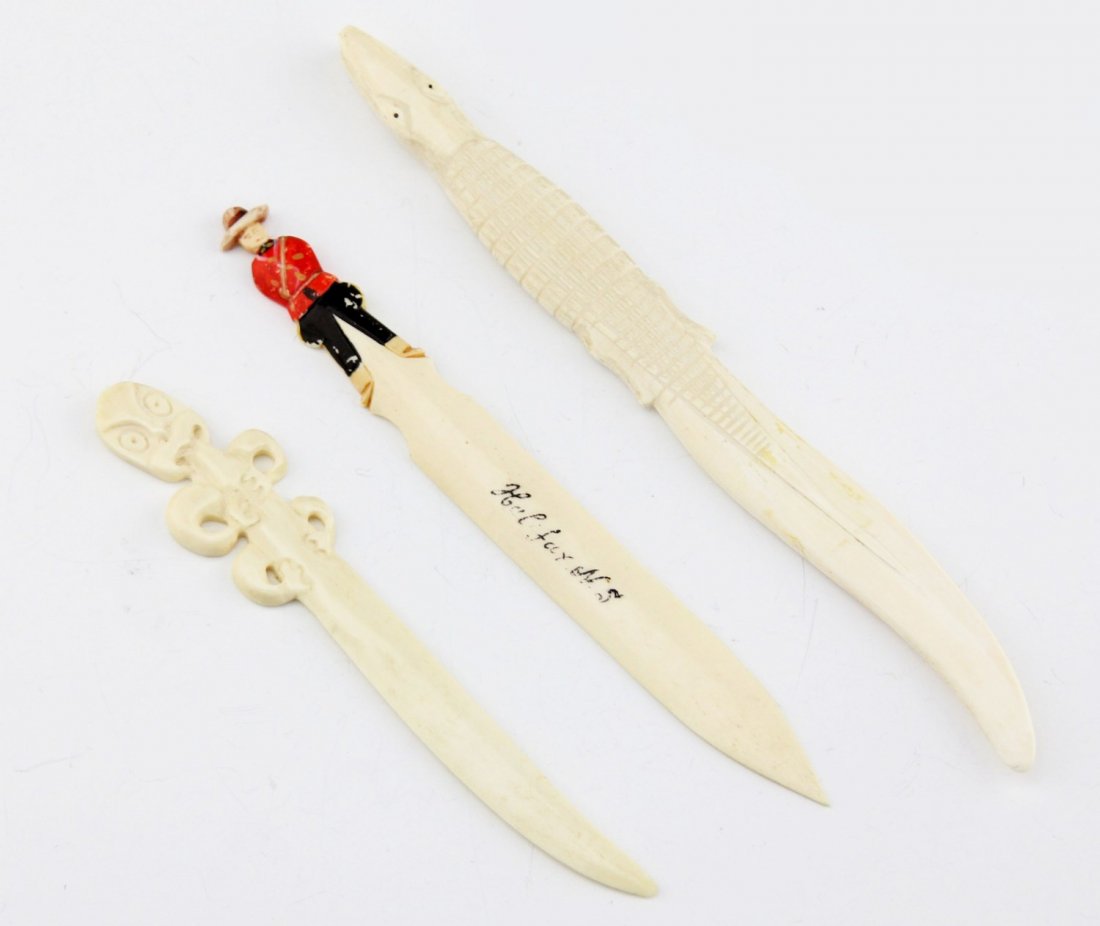 (3) BONE LETTER OPENERS: (3) BONE LETTER OPENERS Three bone letter openers: crocodile, inuit creature, and polychrome Mountie labeled "Halifax, N.S.". Weight: 66 g Size: 6 - 8.5"