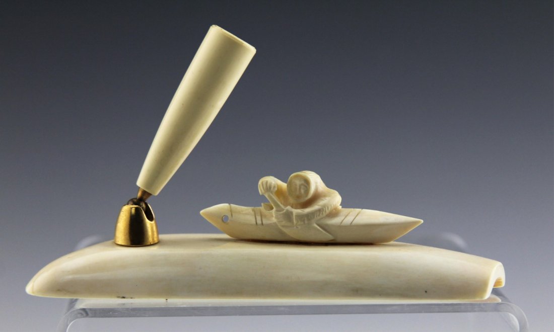 NORTH AMERICAN CARVED IVORY PEN HOLDER ESKIMO: NORTH AMERICAN CARVED IVORY PEN HOLDER ESKIMO Alaskan ivory pen holder featuring Eskimo in canoe. Weight: 112 g Size: 5"