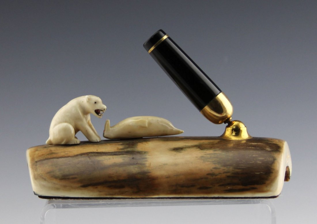FOSSILIZED MARINE IVORY AND BONE PEN HOLDER: FOSSILIZED MARINE IVORY AND BONE PEN HOLDER Fossilized ivory base with two animal figures on top - polar bear and walrus. Weight: 306.8 g Size: 6"