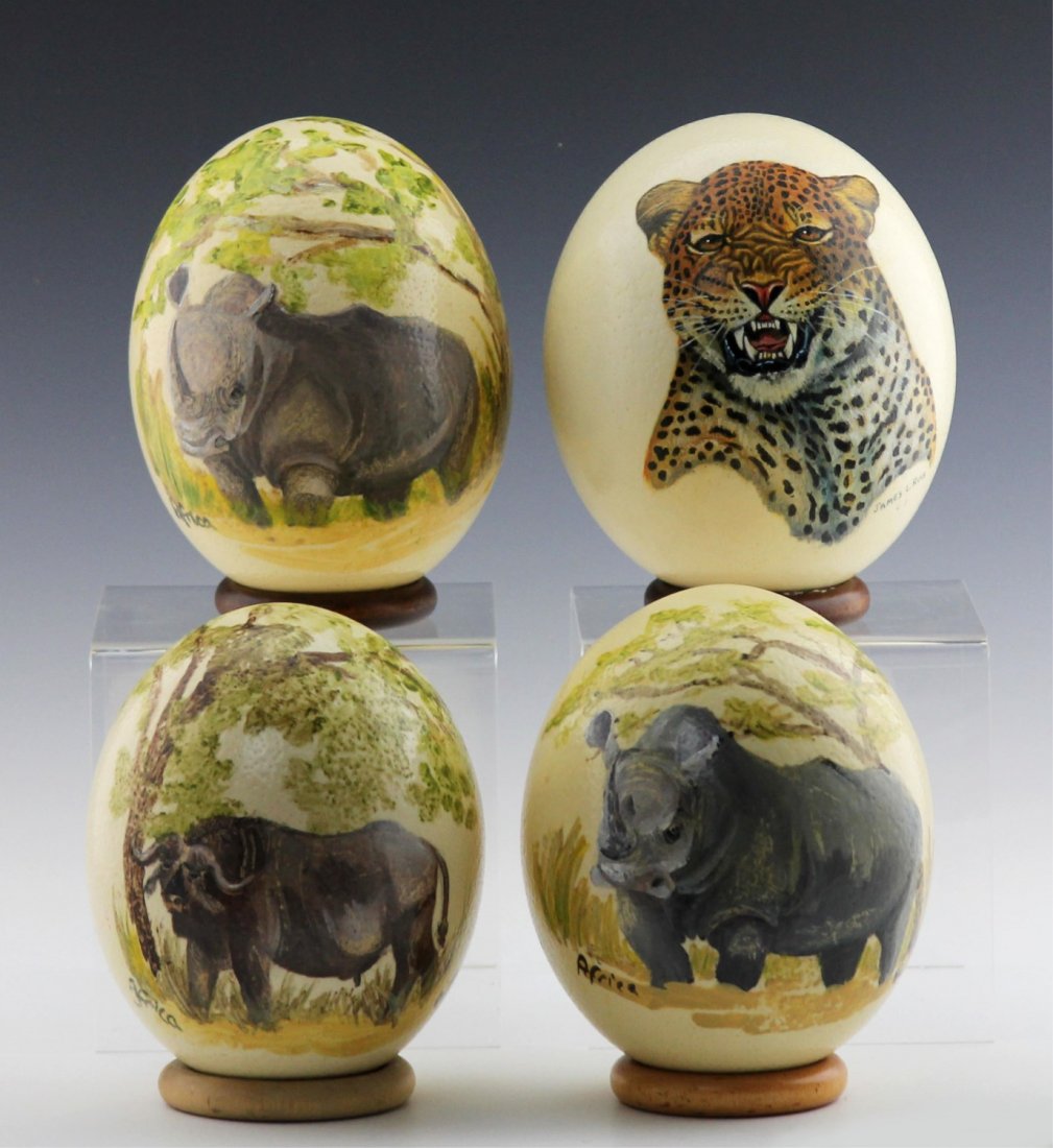 (4) AFRICAN HAND-PAINTED OSTRICH EGG SHELLS: (4) AFRICAN HAND-PAINTED OSTRICH EGG SHELLS A lot of four ostrich egg shells, painted with African wildlife. Each comes with wooden ring stand.