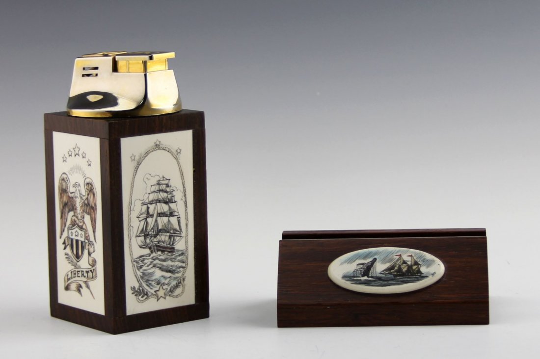 POLYCHROME SCRIMSHAW LIGHTER & CARD HOLDER: POLYCHROME SCRIMSHAW LIGHTER & CARD HOLDER Polychrome scrimshaw desk set. Wooden card and pen holder with oval ivory scrimshaw decoration of nautical scene, 2.5 x 3.5 x 1.65". Wooden lighter with ivor