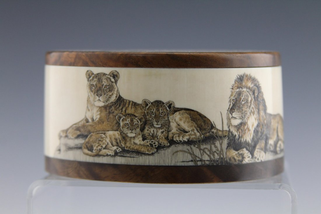 AFRICAN IVORY DRESSER BOX WITH SCRIMSHAW: AFRICAN IVORY DRESSER BOX WITH SCRIMSHAW Ivory dresser box with chestnut base and top, side is decorated with scrimshaw featuring lion family. Weight: 349.4 g Size: 4.75 x 4.5 x 2.25"